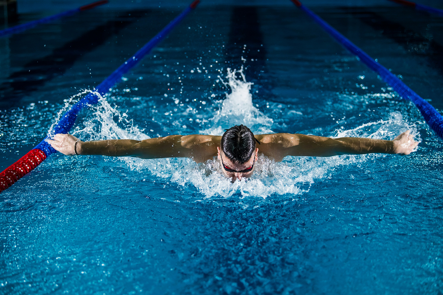 A man is swimming at the pool